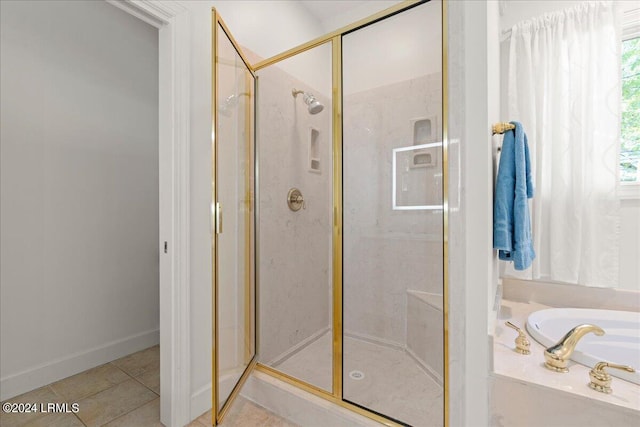 bathroom with tile patterned floors and separate shower and tub