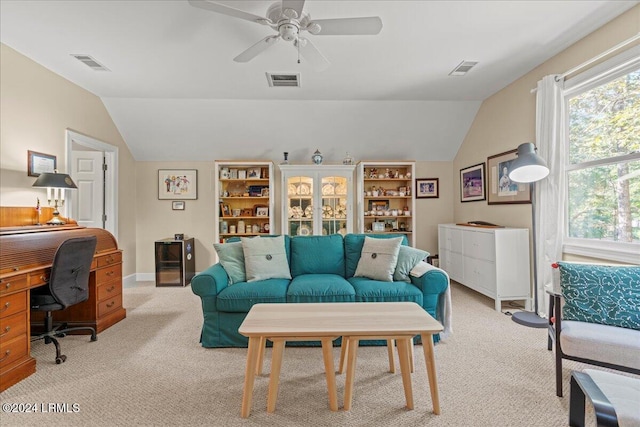 carpeted living room with ceiling fan and lofted ceiling