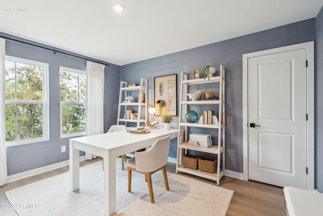 dining area featuring wood finished floors and baseboards