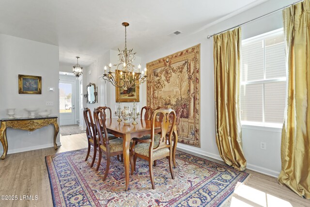 257 Garden Gate Cir E, Hardeeville, SC 29927 - dining area with a chandelier and light wood-style flooring
