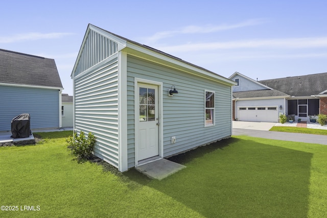 257 Garden Gate Cir E, Hardeeville, SC 29927 - view of home's exterior featuring a yard, board and batten siding, concrete driveway, and an attached garage