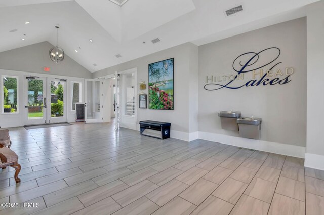 257 Garden Gate Cir E, Hardeeville, SC 29927 - unfurnished living room featuring french doors, high vaulted ceiling, and recessed lighting