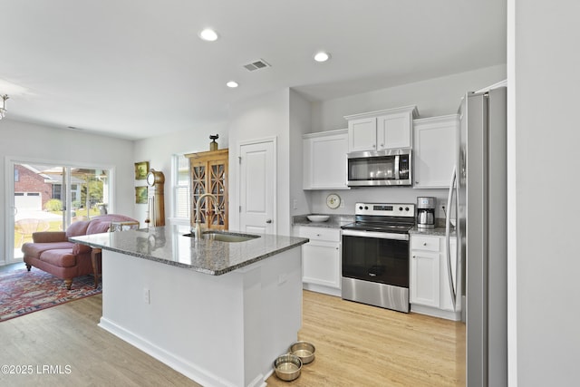 257 Garden Gate Cir E, Hardeeville, SC 29927 - kitchen featuring appliances with stainless steel finishes, light wood-type flooring, white cabinets, stone counters, and recessed lighting