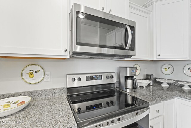 257 Garden Gate Cir E, Hardeeville, SC 29927 - kitchen featuring stainless steel appliances, white cabinetry, and light stone countertops