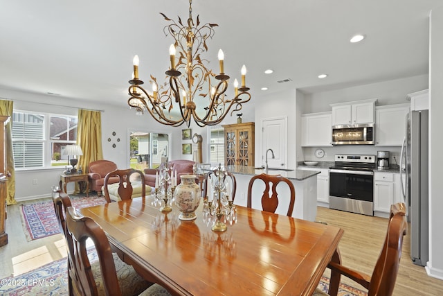 257 Garden Gate Cir E, Hardeeville, SC 29927 - dining space featuring light wood finished floors, a chandelier, and recessed lighting