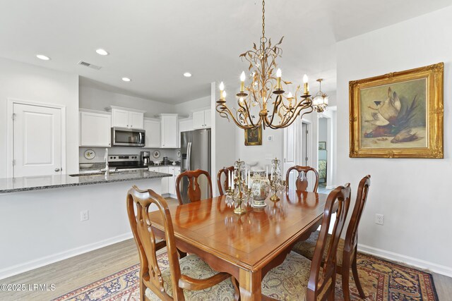 257 Garden Gate Cir E, Hardeeville, SC 29927 - dining room featuring light wood finished floors, recessed lighting, and a chandelier