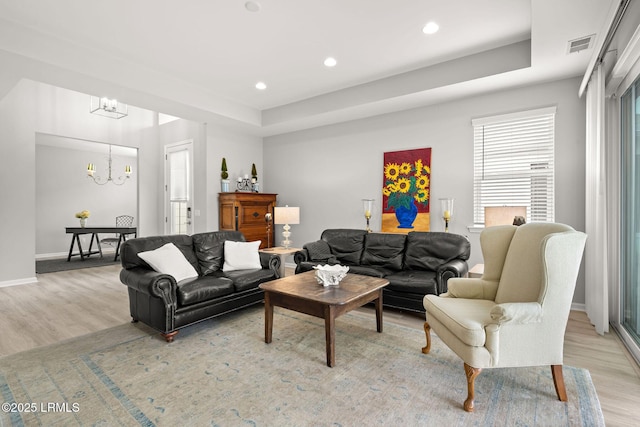 living area featuring recessed lighting, a chandelier, light wood finished floors, baseboards, and visible vents
