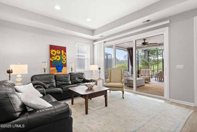 living area with recessed lighting, ceiling fan, light wood finished floors, baseboards, and visible vents
