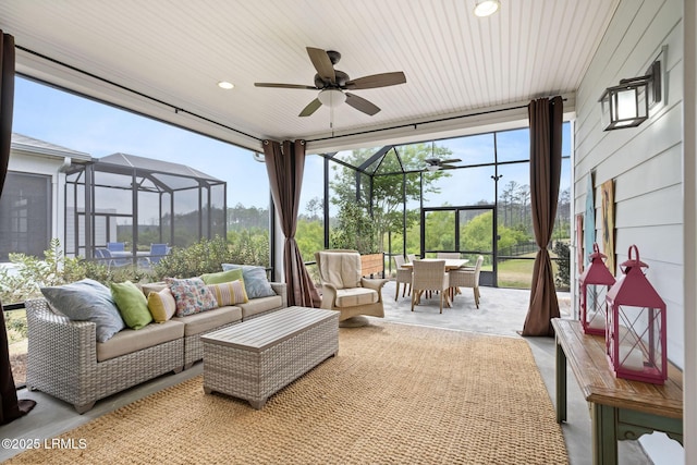 exterior space featuring ceiling fan, an outdoor hangout area, glass enclosure, and outdoor dining area