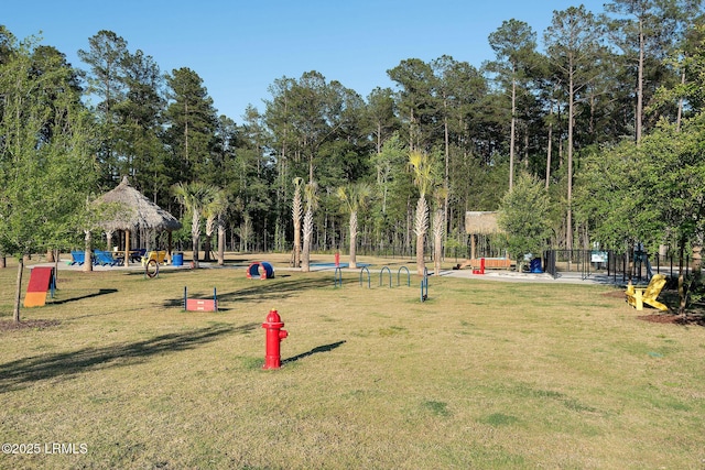 surrounding community featuring a lawn, a gazebo, and fence