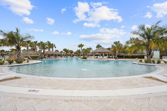pool with a gazebo and a patio