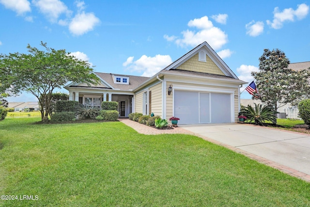 view of front of house with a garage and a front lawn