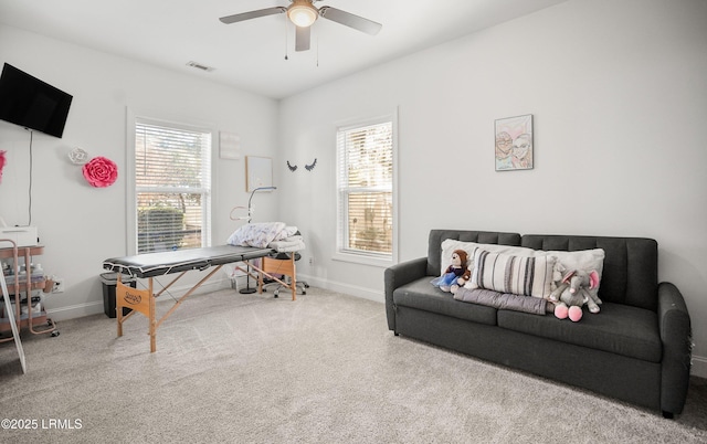 sitting room with ceiling fan, carpet floors, and a wealth of natural light