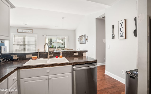 kitchen with stainless steel dishwasher, lofted ceiling, dark hardwood / wood-style flooring, and sink