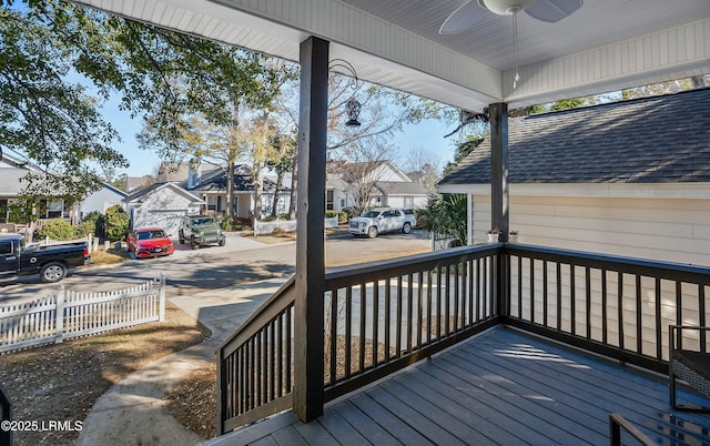 wooden terrace with a porch and ceiling fan