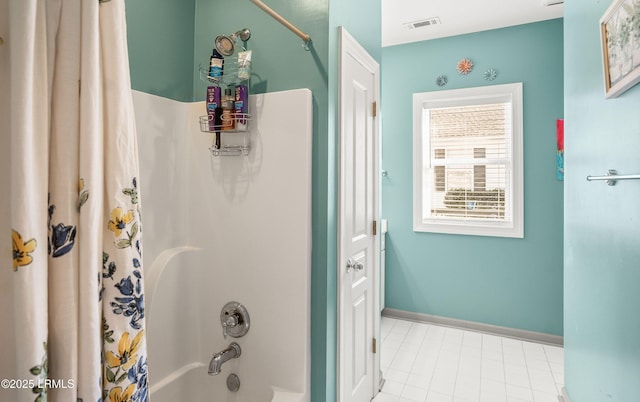 bathroom with shower / bath combo with shower curtain