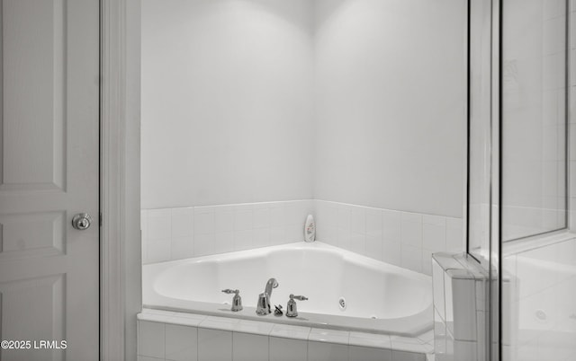 bathroom featuring a relaxing tiled tub