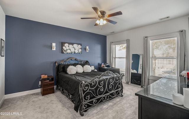 bedroom featuring light colored carpet and ceiling fan