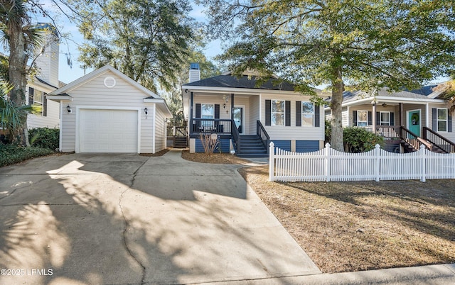 view of front of property featuring a garage, an outdoor structure, and covered porch