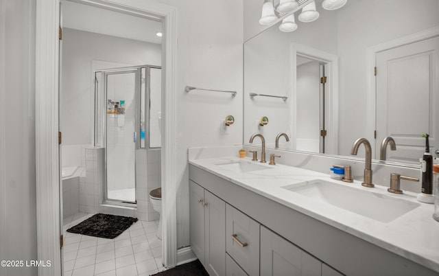 bathroom with vanity, tile patterned floors, a shower with door, and toilet