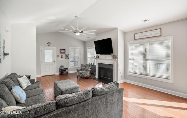 living room featuring hardwood / wood-style flooring, vaulted ceiling, and ceiling fan