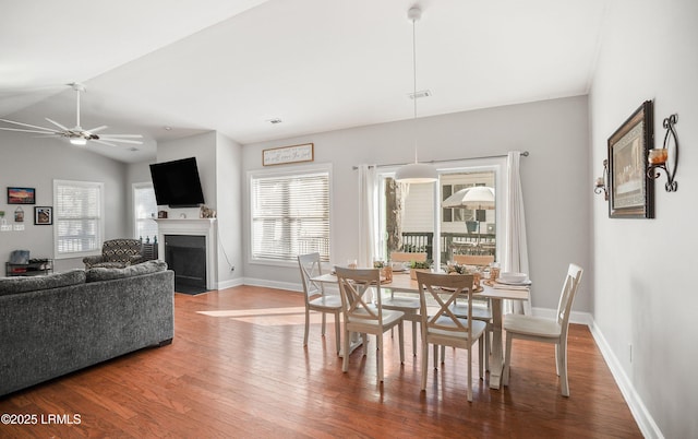 dining space featuring lofted ceiling, hardwood / wood-style floors, and ceiling fan