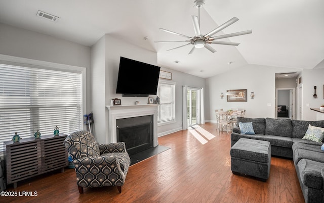 living room with lofted ceiling, dark hardwood / wood-style flooring, and ceiling fan