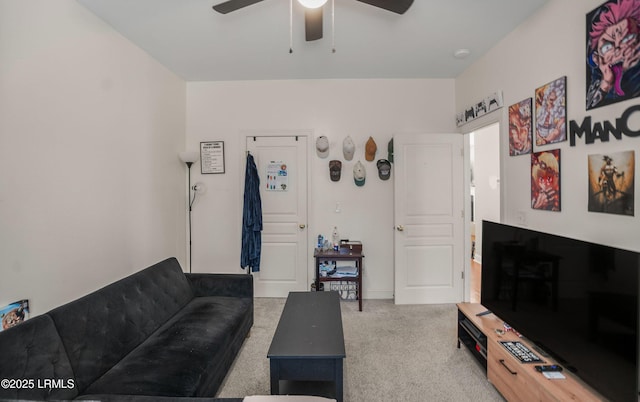 living room featuring ceiling fan and carpet