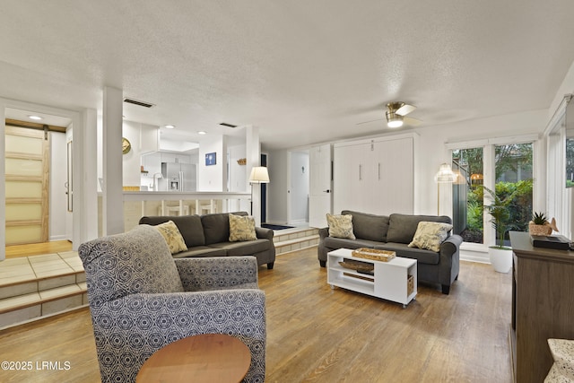 20 Queens Folly Rd Unit 1967, Hilton Head Island, SC 29928 - living room featuring a textured ceiling, wood finished floors, and a ceiling fan