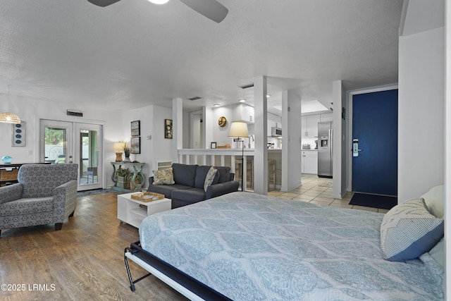 20 Queens Folly Rd Unit 1967, Hilton Head Island, SC 29928 - bedroom featuring stainless steel refrigerator with ice dispenser, access to outside, french doors, a textured ceiling, and light wood finished floors