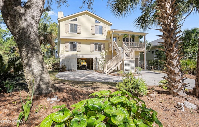 3 Ocean Marsh Ln, Harbor Island, SC 29920 - back of property featuring a carport, stairway, a porch, a chimney, and concrete driveway