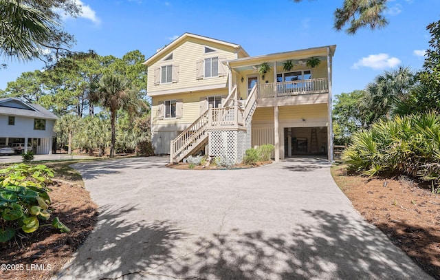 3 Ocean Marsh Ln, Harbor Island, SC 29920 - raised beach house with driveway, stairway, and a porch