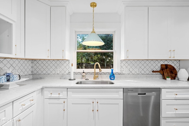 kitchen with sink, hanging light fixtures, stainless steel dishwasher, decorative backsplash, and white cabinets