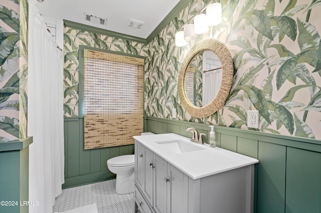 bathroom with tile patterned floors, vanity, and toilet