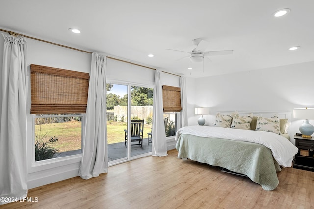 bedroom with multiple windows, access to outside, ceiling fan, and light hardwood / wood-style flooring