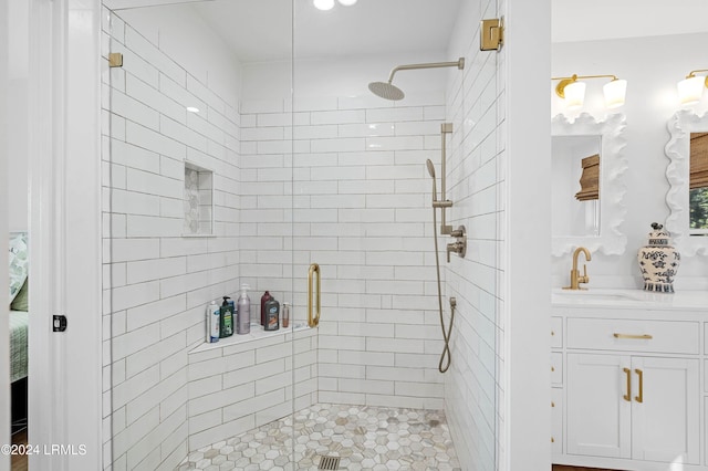 bathroom with a shower with door and vanity