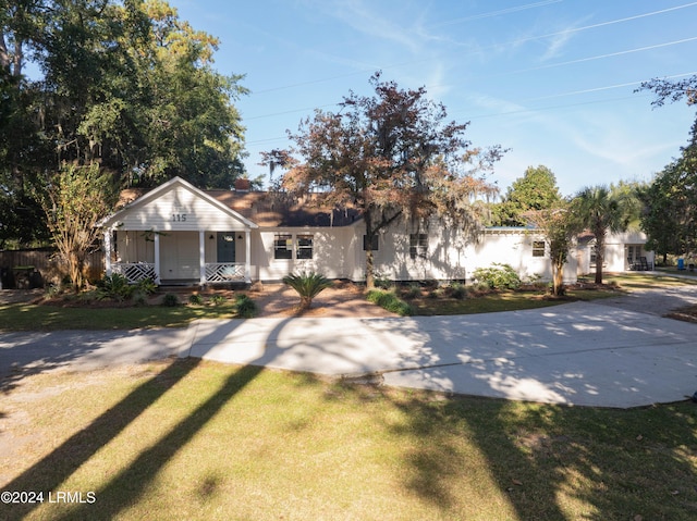 bungalow-style house featuring a porch and a front lawn