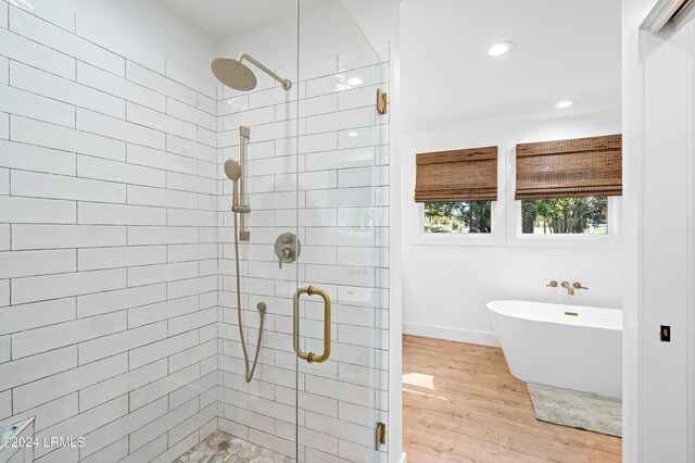 bathroom with hardwood / wood-style flooring and plus walk in shower