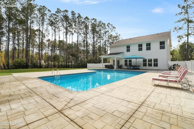 view of pool with a fenced in pool, fence, and a patio
