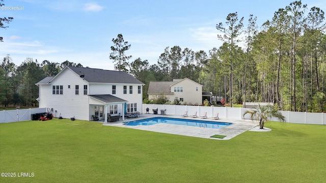 view of swimming pool with a gate, a patio area, a fenced in pool, a fenced backyard, and a lawn