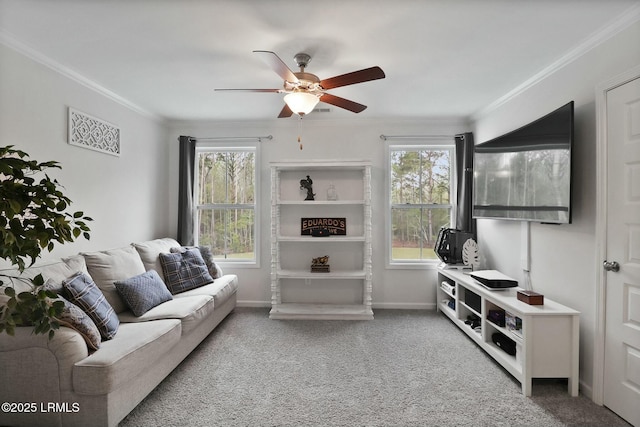 carpeted living room featuring a ceiling fan, crown molding, and baseboards