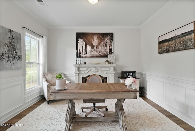 home office featuring a wealth of natural light, crown molding, and dark wood finished floors