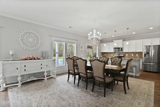 dining room featuring crown molding, recessed lighting, an inviting chandelier, dark wood finished floors, and visible vents