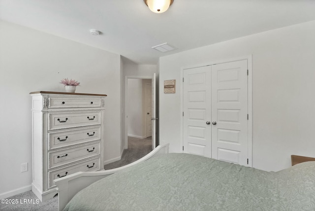 carpeted bedroom with baseboards, visible vents, and a closet