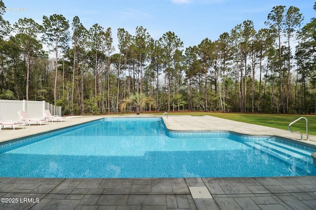outdoor pool featuring fence and a patio