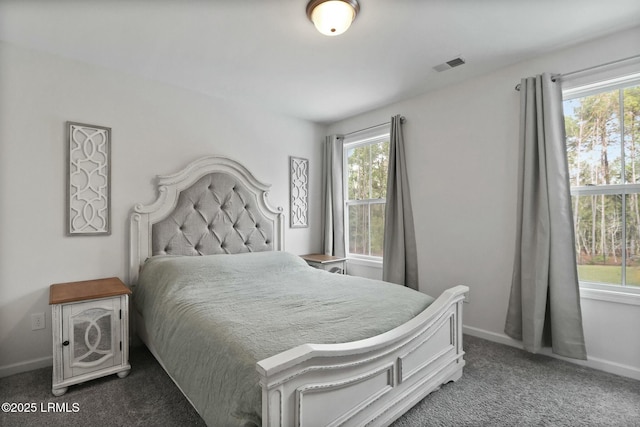 carpeted bedroom featuring baseboards and visible vents