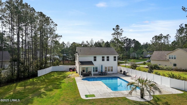 rear view of house featuring a fenced backyard, a fenced in pool, a patio area, and a yard