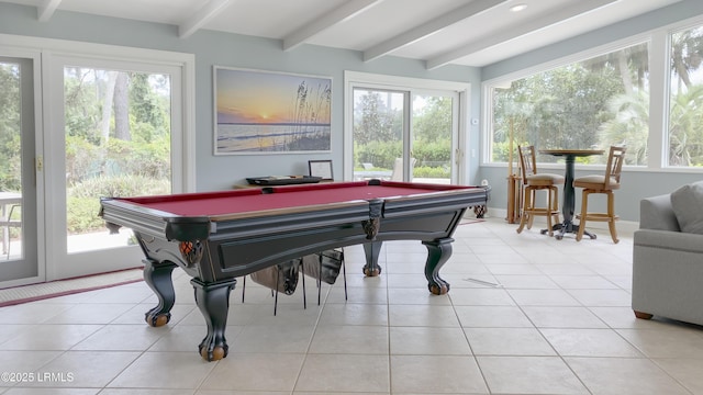 game room with beam ceiling, plenty of natural light, and light tile patterned flooring