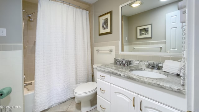 full bathroom featuring vanity, toilet, tile patterned flooring, and tile walls