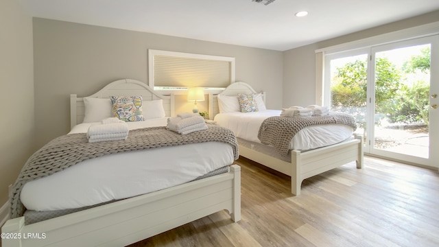 bedroom featuring access to exterior and light hardwood / wood-style floors